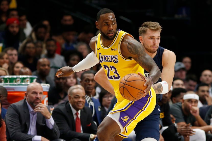 Luka Doncic and LeBron James hug each other after the game