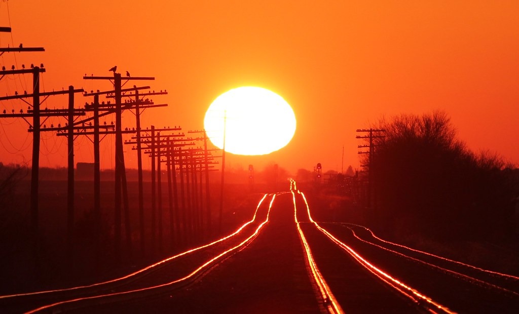 Witness the annual miracle as the sun’s mesmerizing reflection dances upon the railroad tracks, inviting you to capture a photograph that encapsulates the enchantment of this fleeting moment in time.vouyen