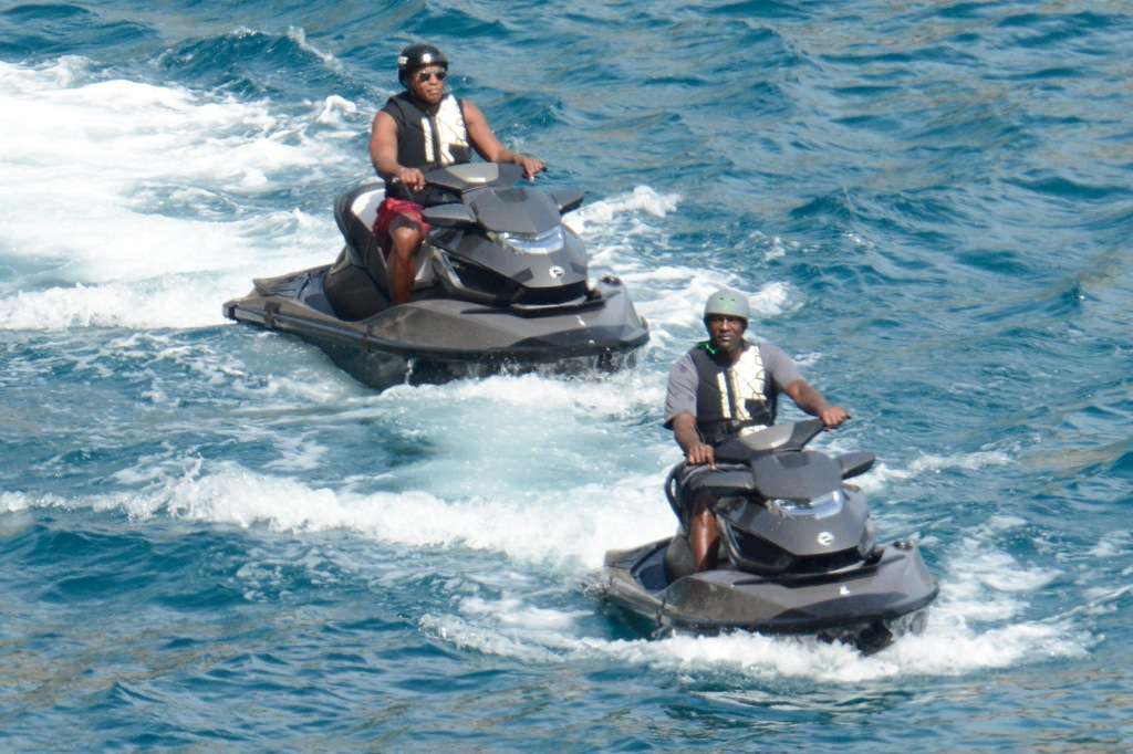 As he jet skis across Italy, Michael Jordan covers his head