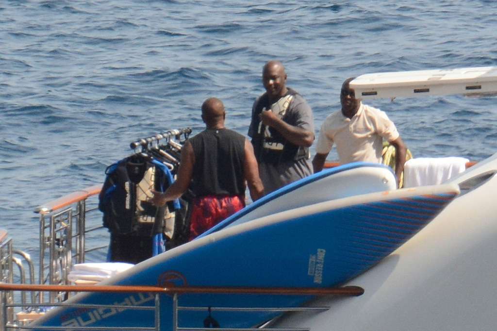 As he jet skis across Italy, Michael Jordan covers his head