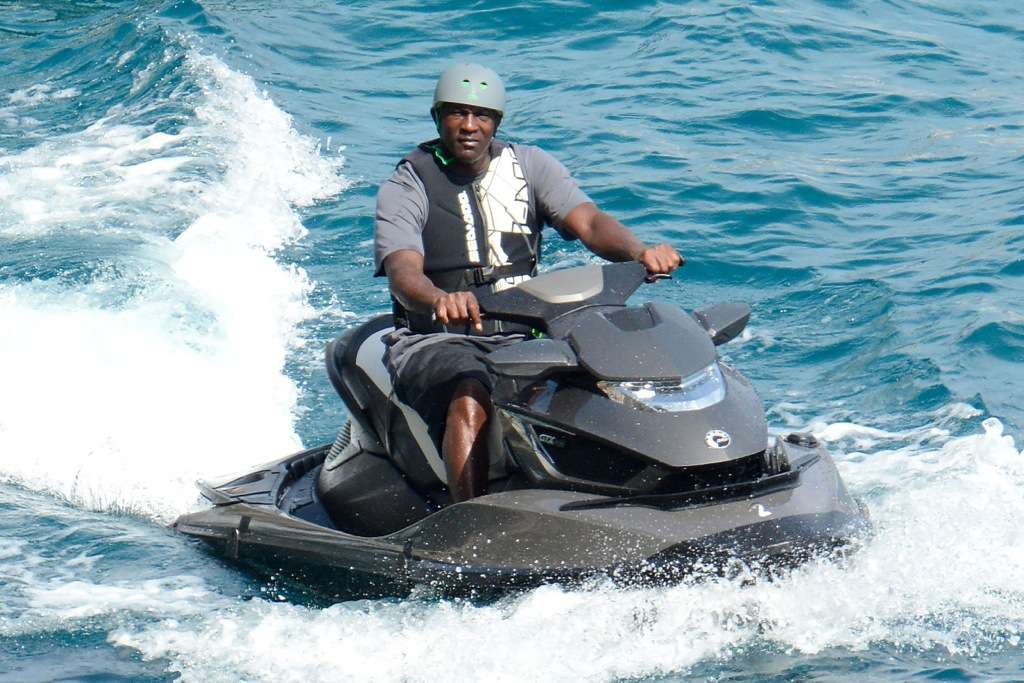 As he jet skis across Italy, Michael Jordan covers his head