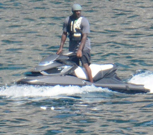 As he jet skis across Italy, Michael Jordan covers his head